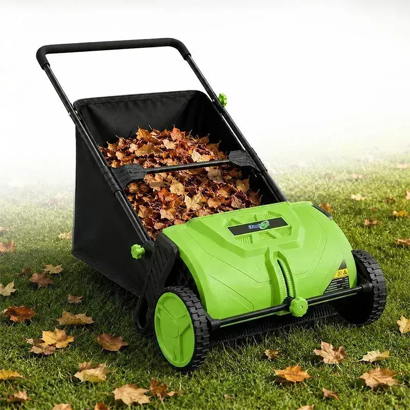 iToolMax 22 inch Push Lawn Sweeper with green housing on a leaf-covered lawn